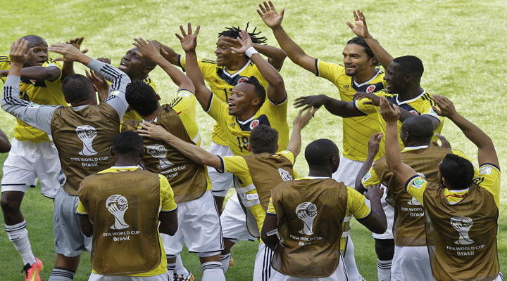 Colombia's players dance in celebration.