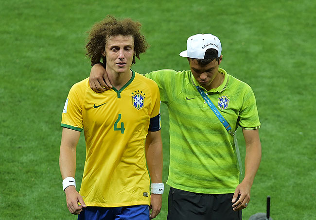 Brazil's defender David Luiz (R) is consoled by Brazil's defender and captain Thiago Silva